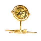 An antique brass gimbal compass with a stand, featuring a classic design and a golden finish.